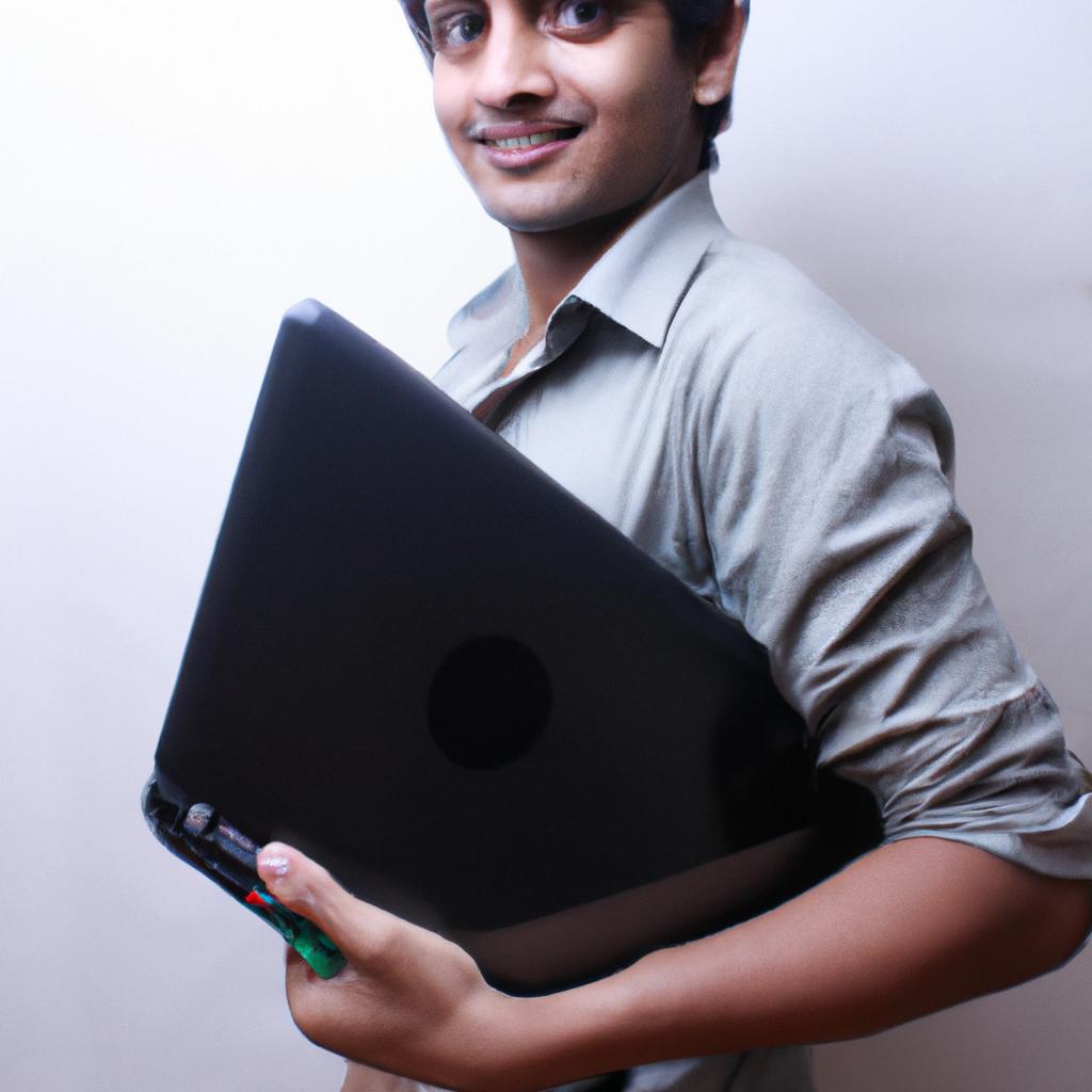 Person holding a laptop, smiling