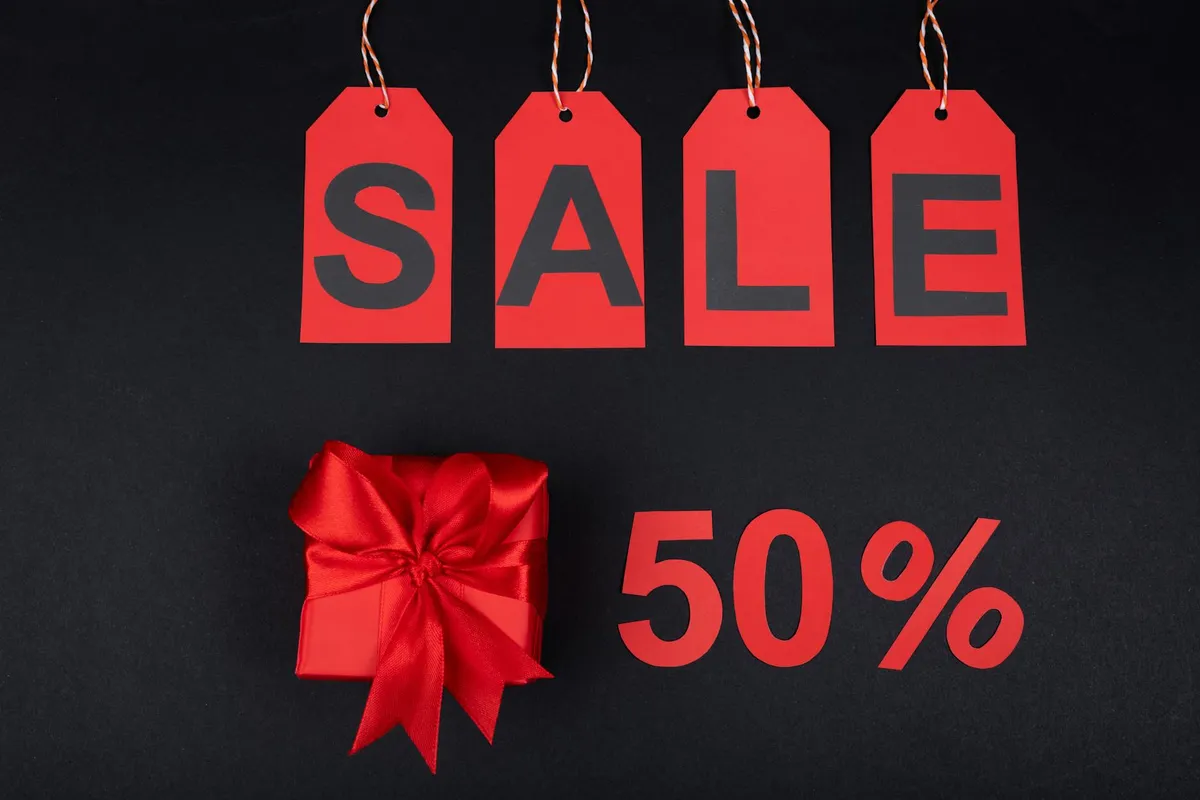 A bright discount tag and shopping items signaling savings