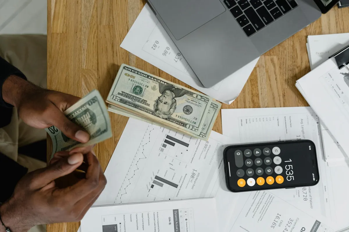 A calculator and budget spreadsheet on a modern desk